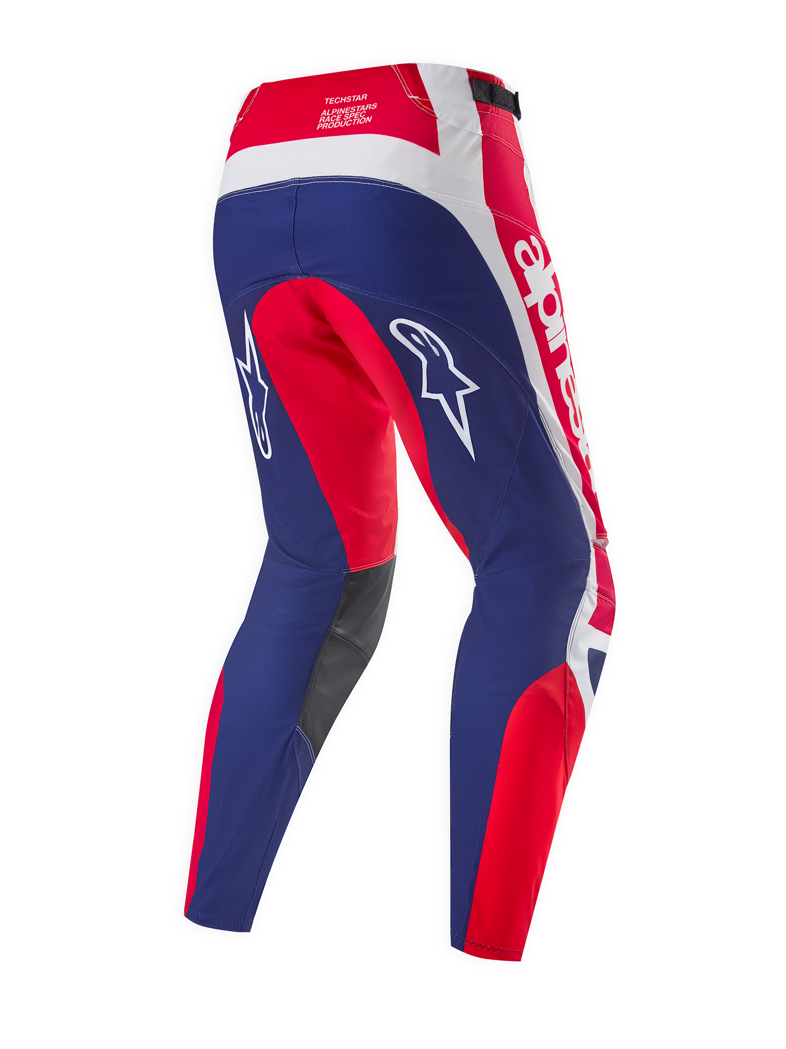 Pantalones Alpinestars Techstar Fortitude Edición Limitada, pantalones de motocross, rojo brillante, blanco y azul, vista trasera que destaca los paneles ergonómicos de competición, logotipos de Alpinestars en blanco y paneles interiores de las rodillas en gris oscuro.