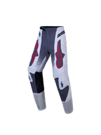 Alpinestars Supertech Swan Juvenil, pantalones de motocross, gris y blanco con logos de estrellas rojas, ajuste atlético y tejido rip-stop