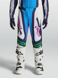 Alpinestars Pantalones Supertech Maven Juvenil, equipo de motocross blanco y azul con detalles verde flúor y rosa.