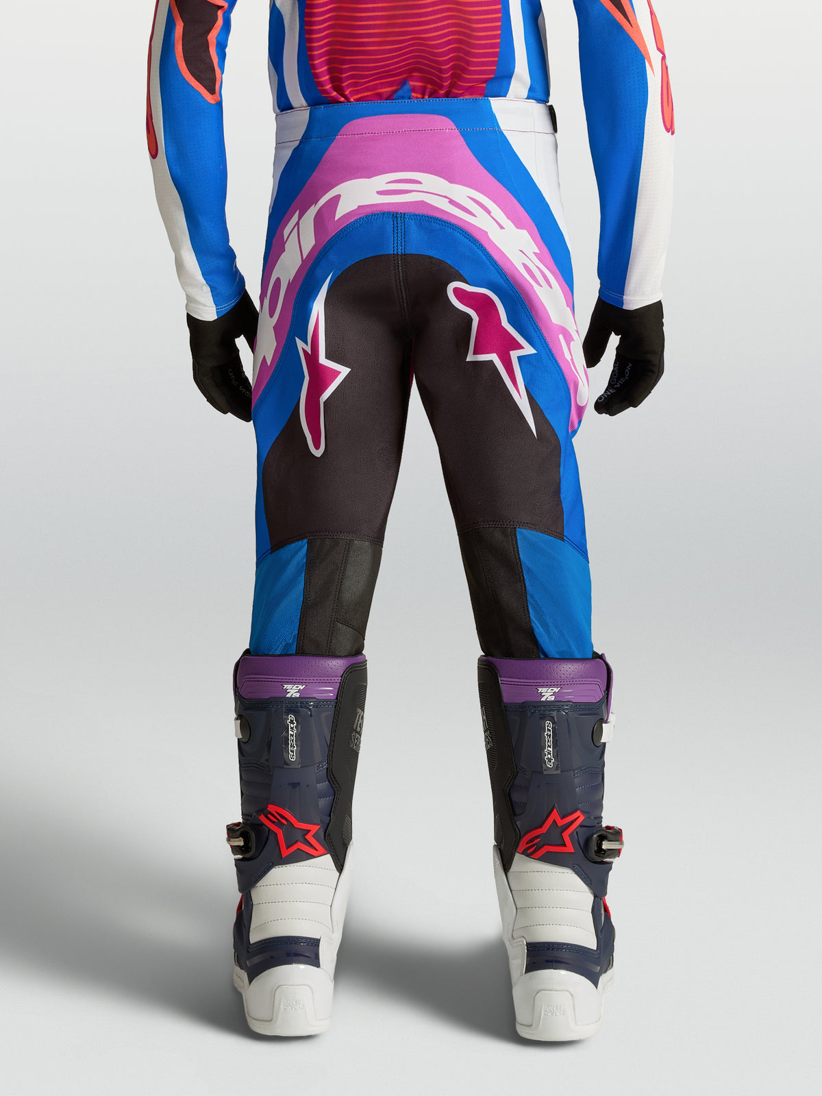 Alpinestars Youth Supertech Maven Motocross Pants in Blue and Hot Coral, featuring a reinforced seat and athletic fit.