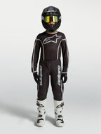 Alpinestars Youth Fluid Apex V2 Pants, black and silver motocross gear set with matching jersey and white boots.