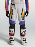 Alpinestars pantalones Fluid Drag juvenil para motocross, blancos y azules con gráficos dorados, ajuste ergonómico.