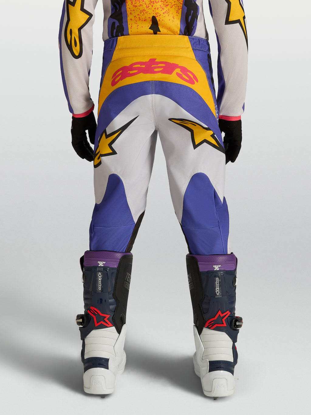 Pantalones Alpinestars Fluid Drag Juvenil, equipo de motocross para niños en azul y dorado, construcción duradera de poliéster 600D con gráficos de estrellas, vista trasera