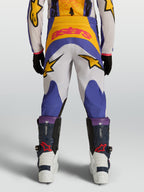 Pantalones Alpinestars Fluid Drag Juvenil, equipo de motocross para niños en azul y dorado, construcción duradera de poliéster 600D con gráficos de estrellas, vista trasera