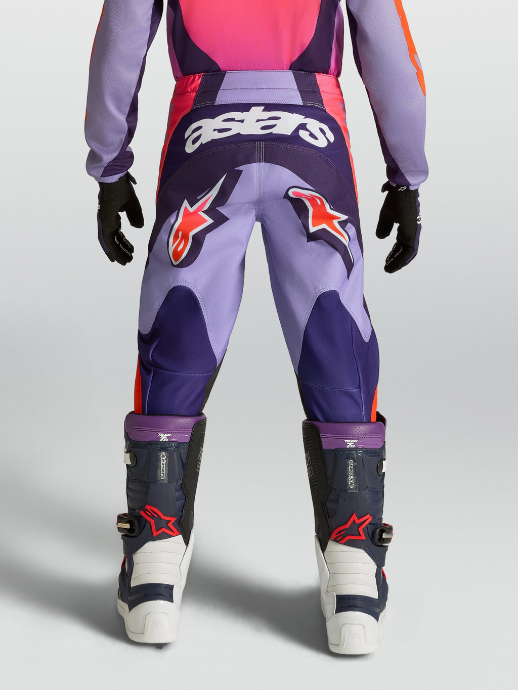 Alpinestars pantalones Fluid Hunt juveniles, equipo de motocross morado y rosa con logos de estrella y tejido resistente.