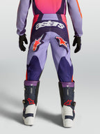 Alpinestars pantalones Fluid Hunt juveniles, equipo de motocross morado y rosa con logos de estrella y tejido resistente.