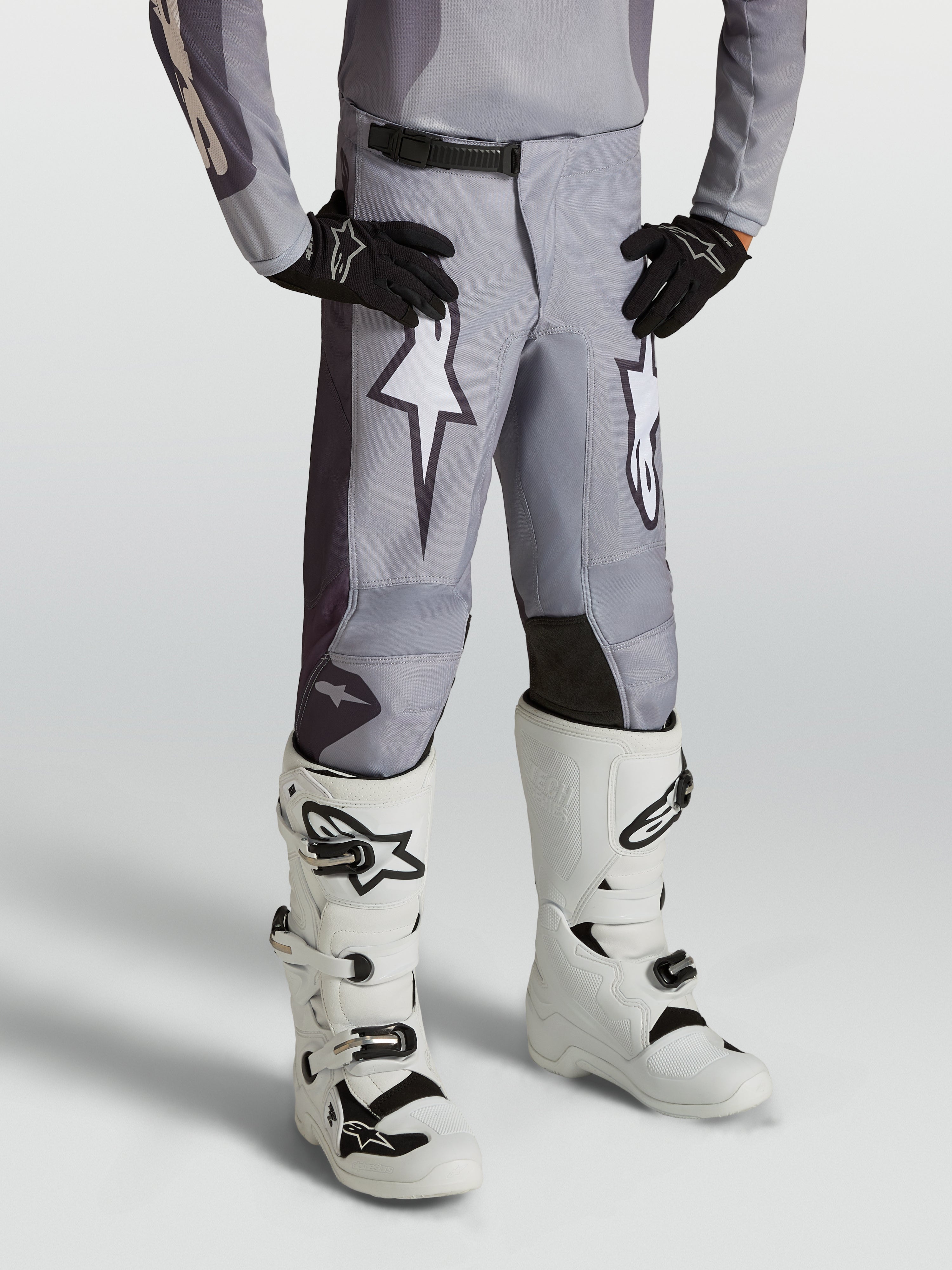 Pantalones Alpinestars Fluid Amber Juvenil, pantalones de motocross para niños, gris arena y blanco, gráficos de estrellas, paneles reforzados y ajuste deportivo para off-road