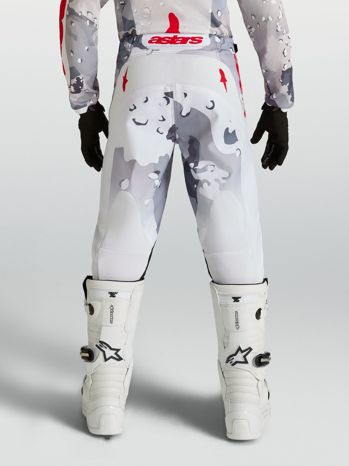 Alpinestars Youth Fluid Lone Pants, Gray Camo and White motocross pants with Red accents, rear view on rider.