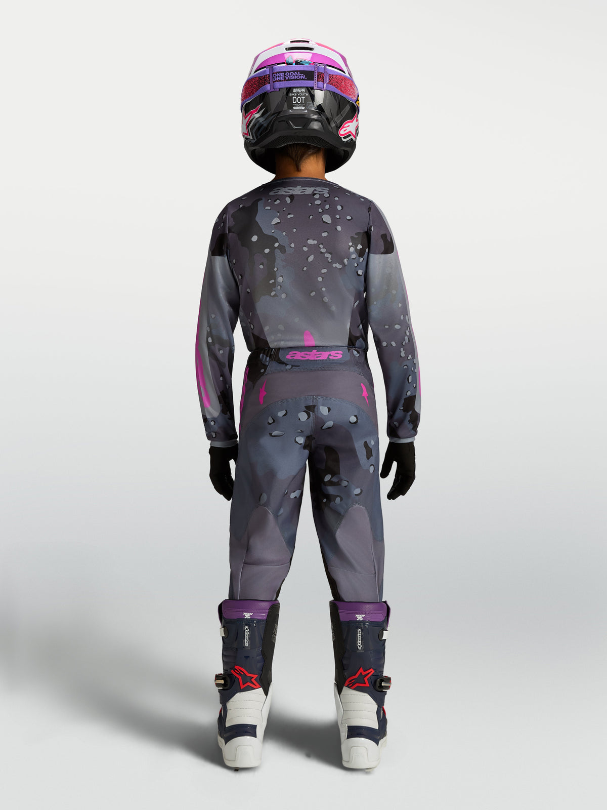 Jersey y pantalón Alpinestars Fluid Lone Juvenil, equipo de motocross gris y morado con camuflaje, vista trasera del piloto.