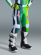 Alpinestars 2026 Youth Fluid Portl Pants, Motocross Pants, Green White and Black, featuring pink star logos on the thighs, worn with matching jersey and white and black boots, durable design for youth off-road racing