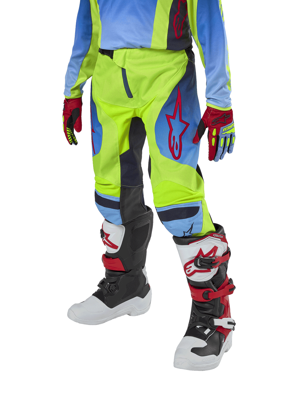 Alpinestars Pantalones Racer Hoen Juveniles 2024, pantalones de motocross, amarillo fluorescente y azul marino noche con detalles rojos, usados con guantes a juego y botas blancas, negras y rojas, con ajuste deportivo y piernas precurvadas para carreras todoterreno