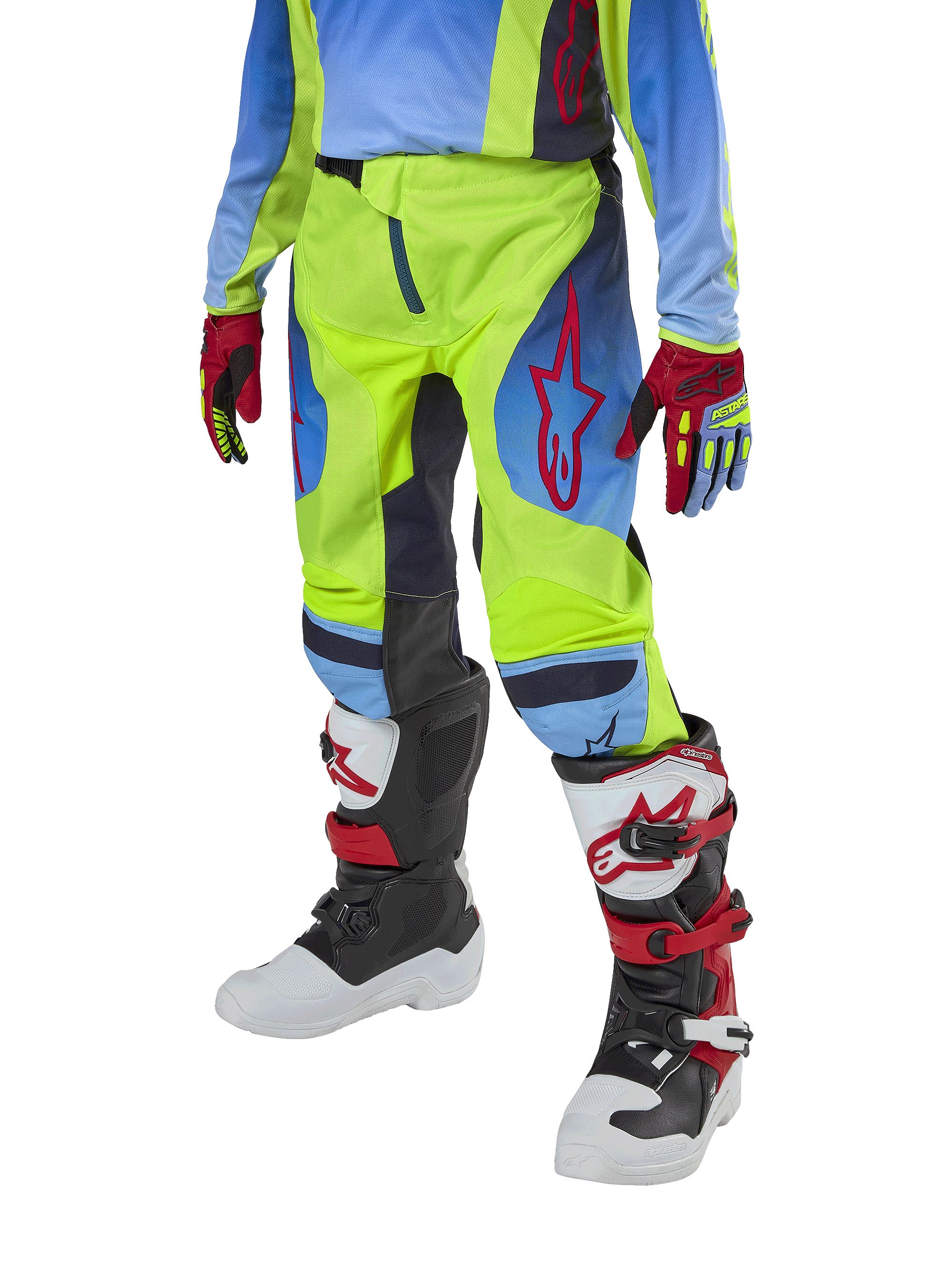 Alpinestars Pantalones Racer Hoen Juveniles 2024, pantalones de motocross, amarillo fluorescente y azul marino noche con detalles rojos, usados con guantes a juego y botas blancas, negras y rojas, con ajuste deportivo y piernas precurvadas para carreras todoterreno