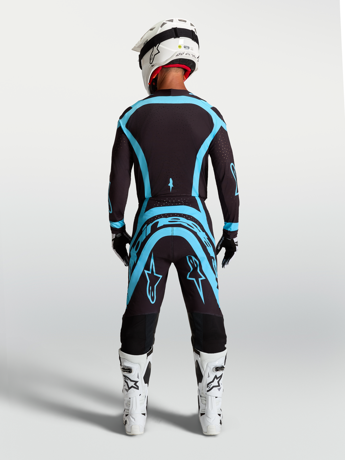 Alpinestars Supertech Vesta, conjunto de motocross, negro y turquesa, vista trasera de jersey y pantalones, ajuste atlético.
