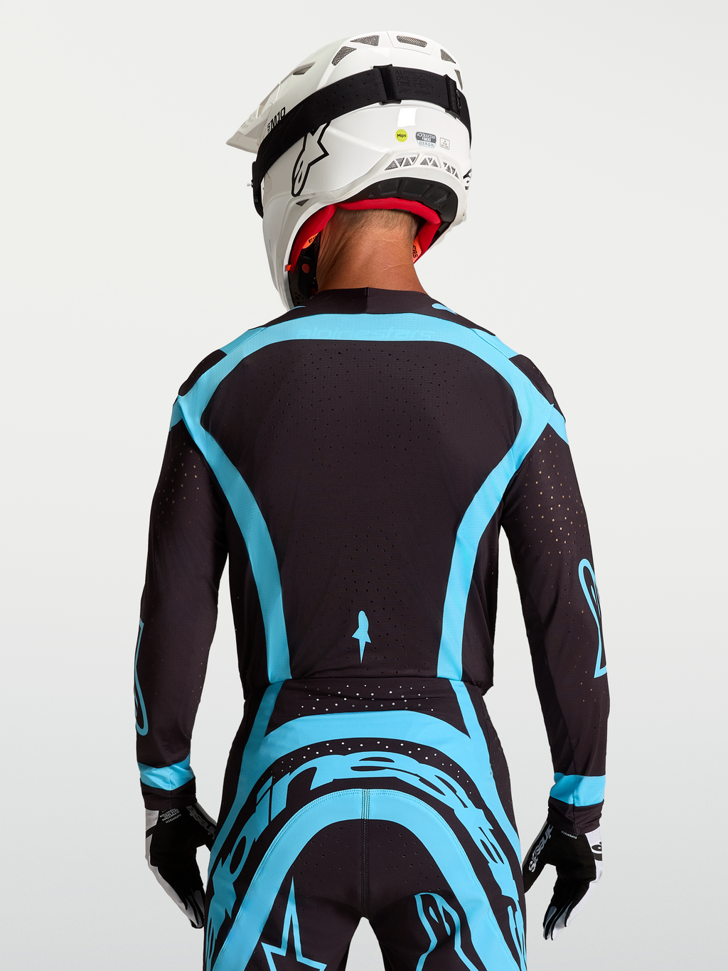 Jersey Supertech Vesta de Alpinestars para motocross, hombre, negro y turquesa, con malla elástica y perforaciones láser.