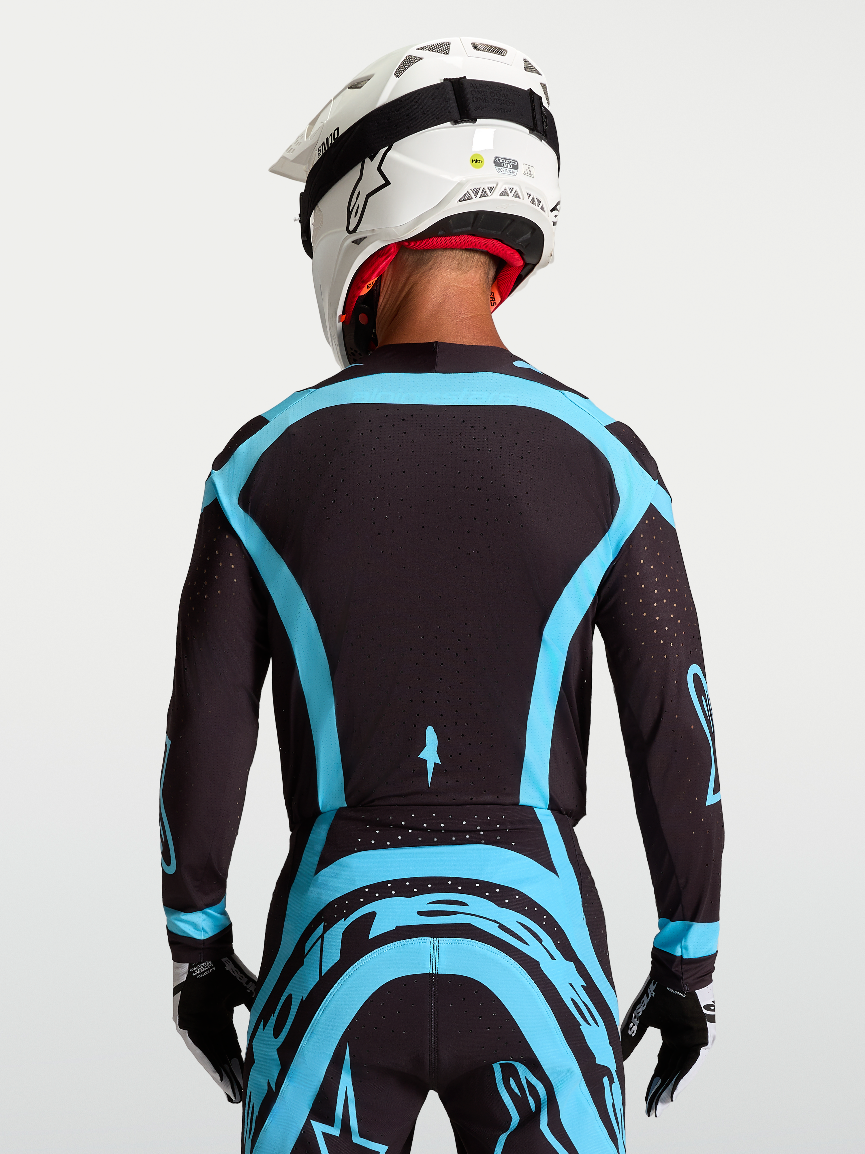 Jersey Supertech Vesta de Alpinestars para motocross, hombre, negro y turquesa, con malla elástica y perforaciones láser.
