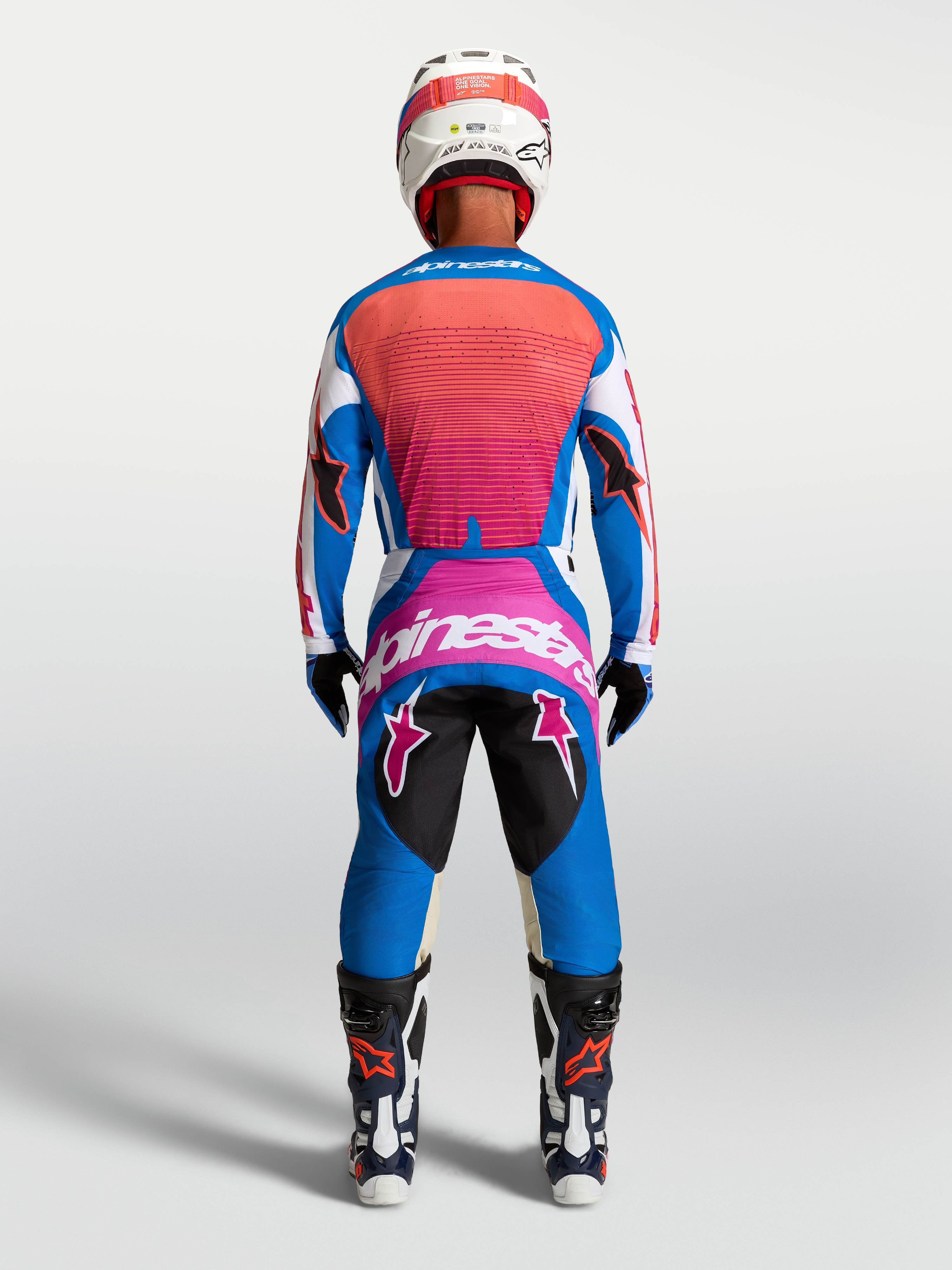 Alpinestars Techstar Maven Jersey y Techstar Maven Gear Set, azul y coral vivo, equipación de motocross, vista posterior.