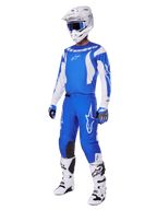 Motocross rider wearing the complete 2025 Fluid Haul Gear Set, Blue and White jersey and pants with Alpinestars branding, white helmet with blue goggles, white boots, and blue gloves, coordinated racing outfit for off-road motocross.