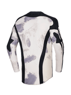 Jersey Alpinestars Racer Lahnd 2026, jersey de motocross, camuflaje arena con patrones de pinceladas en blanco roto y gris, vista posterior con paneles de malla negra verticales, cuello negro y perfil trasero extendido para mayor cobertura
