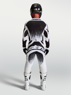 Jersey y conjunto Techstar Swan de Alpinestars para motocross, blanco y negro con gráficos traseros de efecto salpicadura.