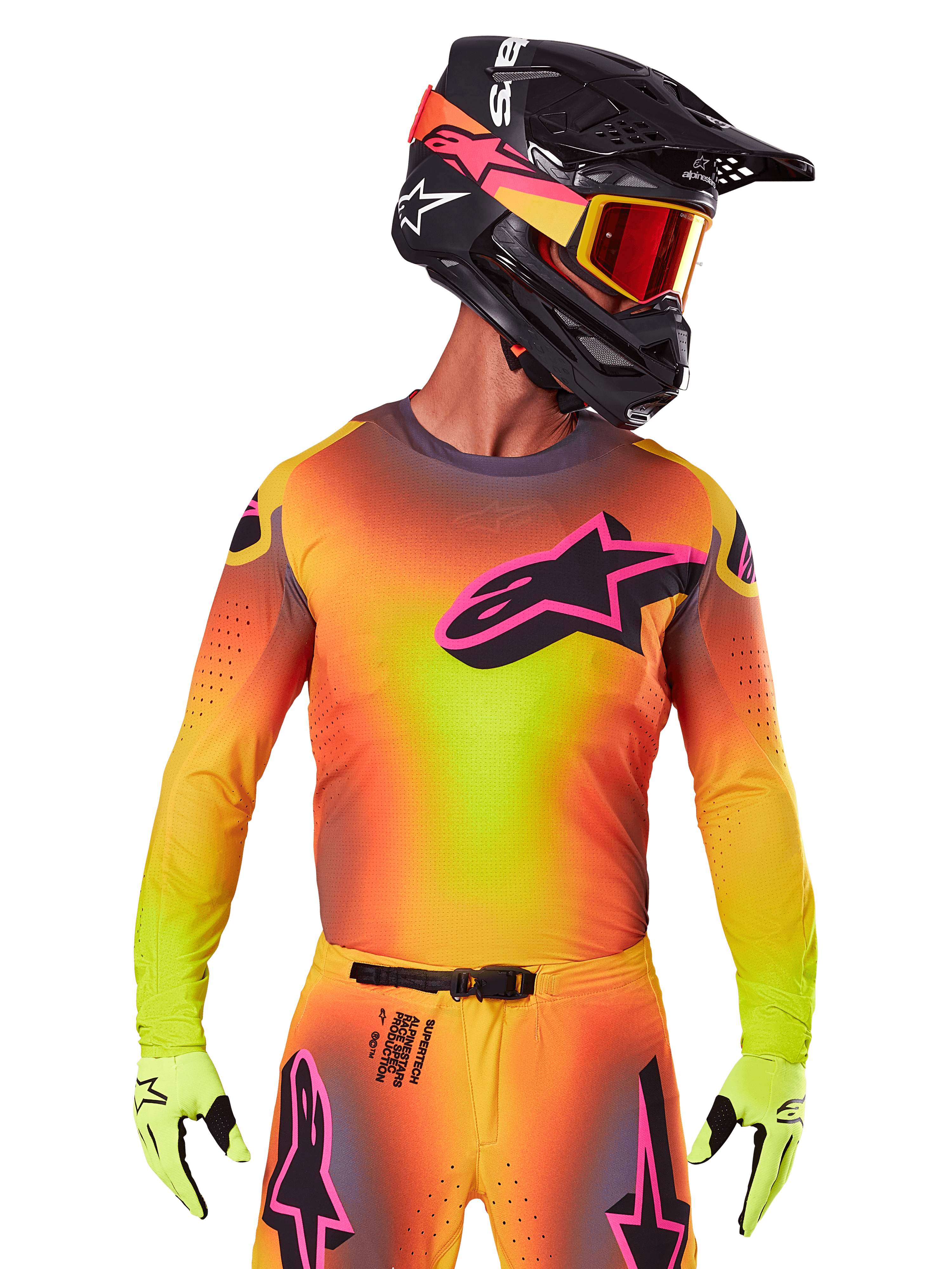 Motocross rider wearing the 2025 Supertech Lipan Jersey, vibrant yellow orange and pink gradient colorway, large black Alpinestars star logo with pink outline on the chest, laser-cut perforations for ventilation, athletic race fit, paired with matching pants, yellow gloves, and a black helmet with goggles.