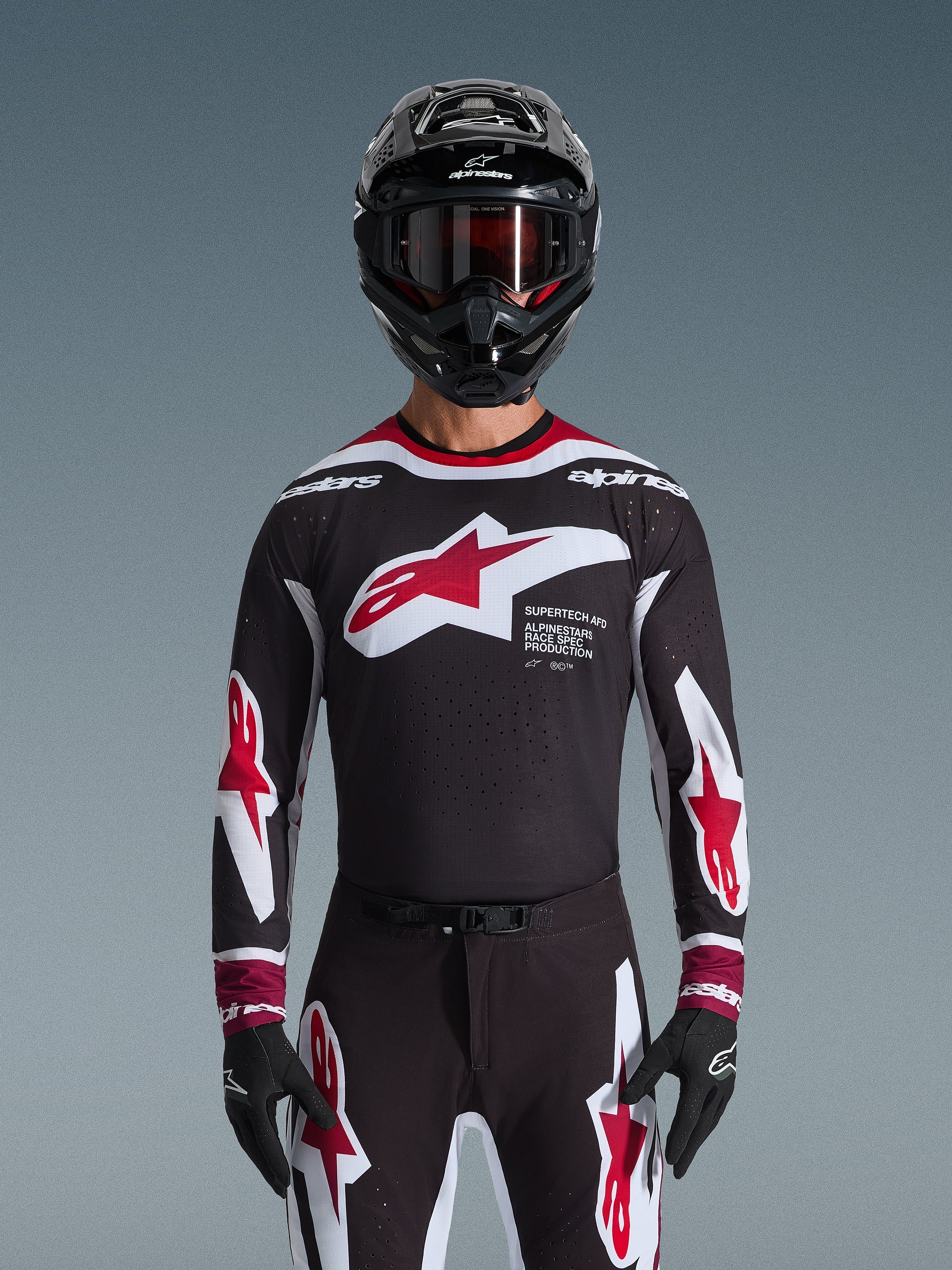 Alpinestars 2026 Supertech AFD Vista Gear Set, Motocross Gear Set, black jersey with red and white logos and 'Supertech AFD' branding, matching black pants with red accents, black helmet with red goggles, coordinated professional racing outfit