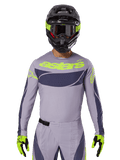 2025 Techstar Dreem Jersey and Gear Set, Motocross racing outfit, light gray and dark gray with neon yellow accents, features 'astars' branding, worn with black helmet, goggles, and matching gloves, technical perforated material for off-road performance