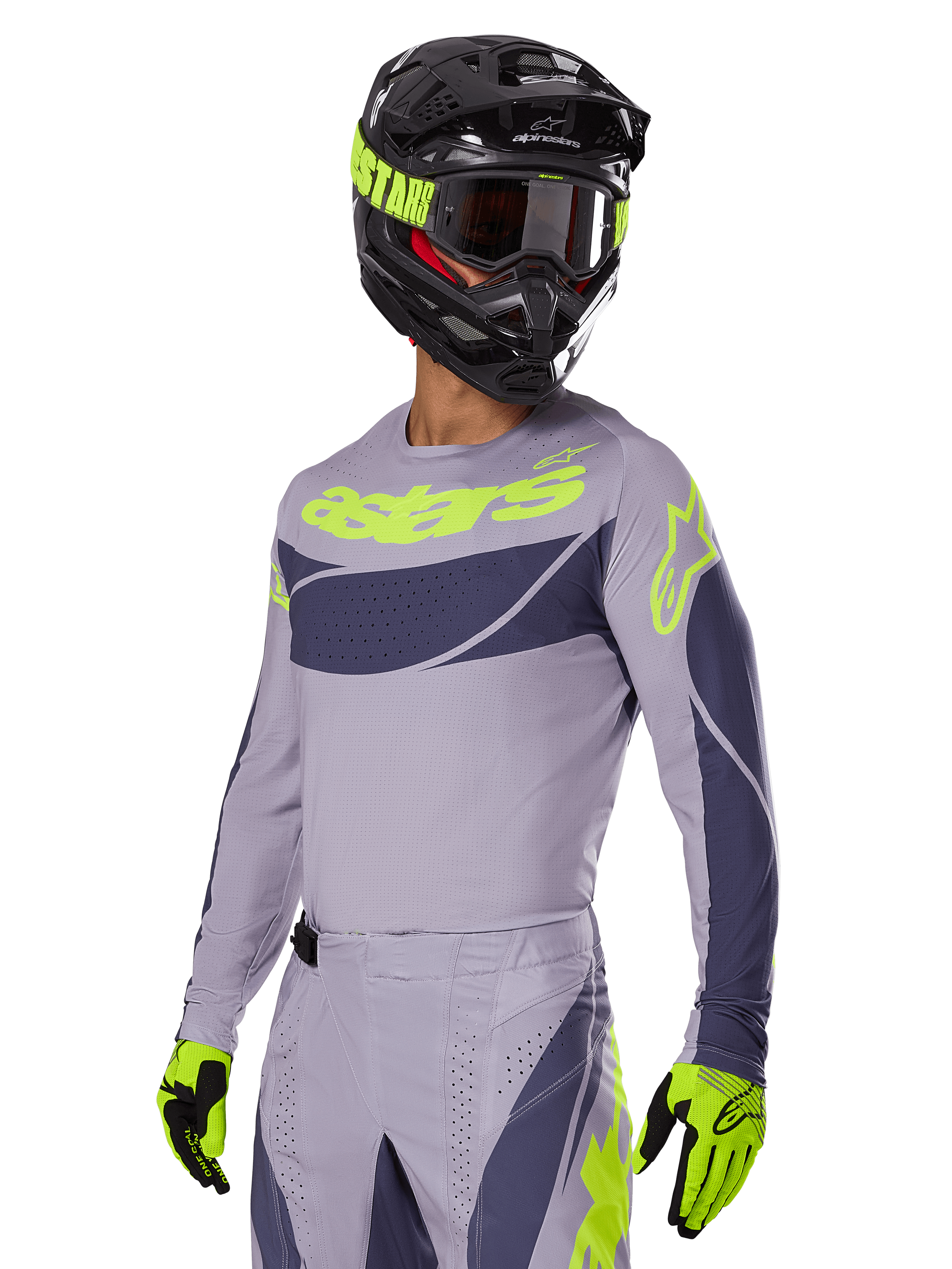 Motocross rider wearing Alpinestars 2025 Techstar Dreem Jersey, Gray and Dark Gray with lime green logos, matching pants, black helmet with lime green accents, lime green and black gloves, coordinated outfit for off-road racing