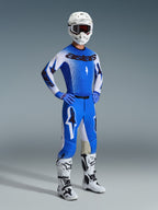 Motocross rider wearing the Alpinestars 2026 Supertech Scenz Gear Set in Ucla Blue and White, featuring a pro-level jersey with 'astars' branding, matching performance pants, white helmet, dark goggles, and white and black off-road boots.