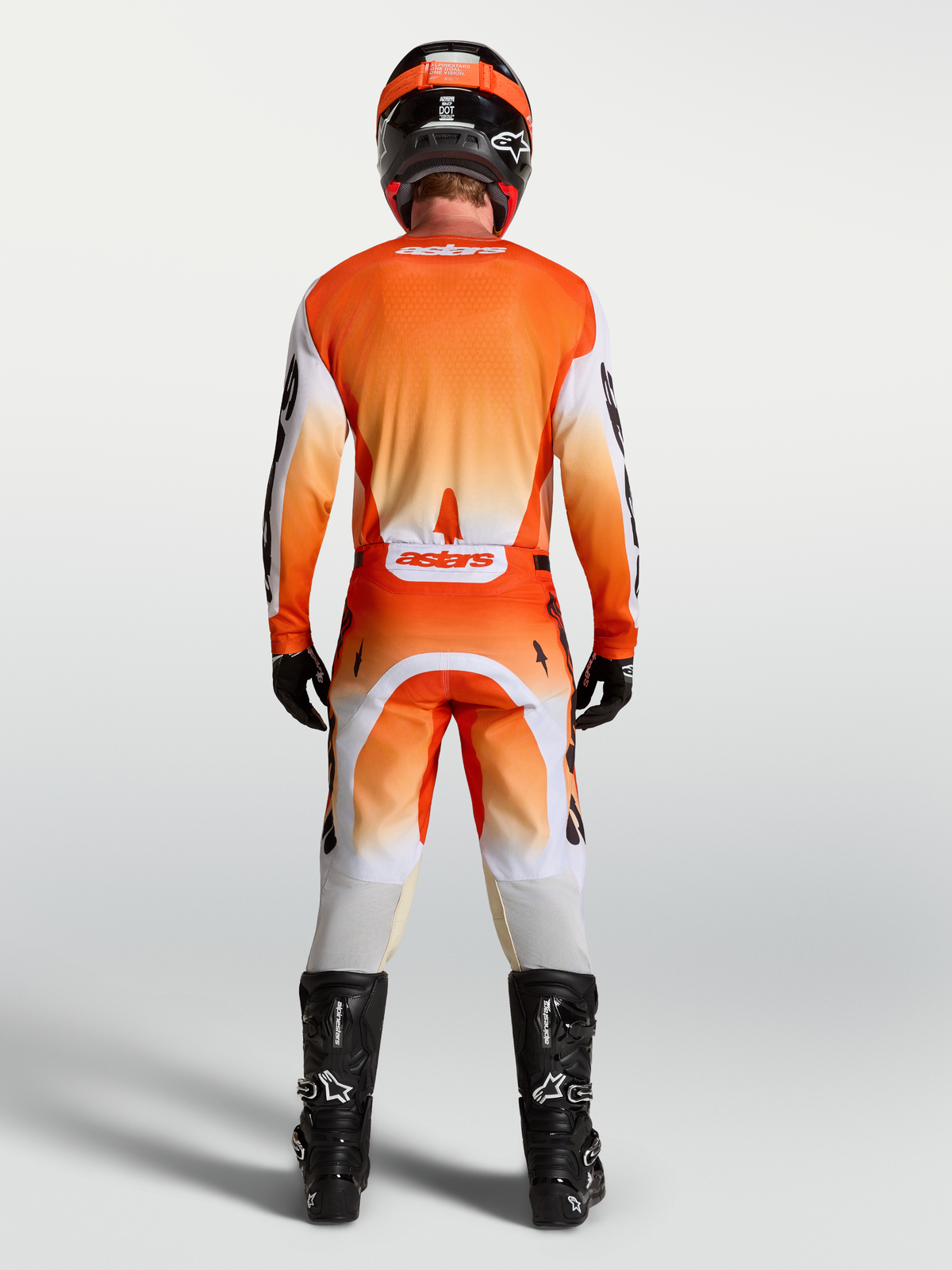 Alpinestars Racer Amber pants y gear set, equipación de motocross para hombre, naranja y blanca, vista trasera.