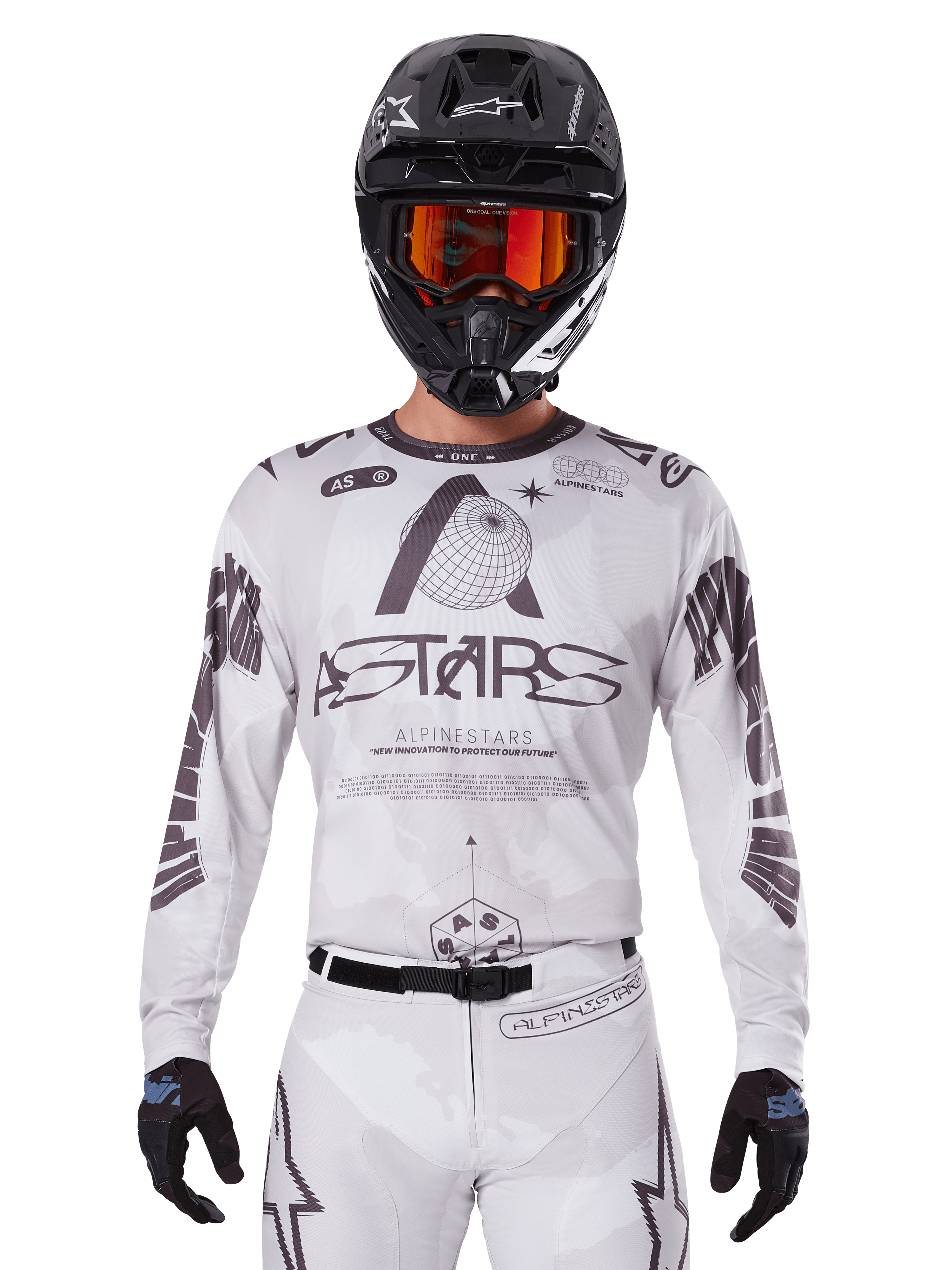 Alpinestars 2025 Racer Hollow Jersey, camiseta de motocross, blanca y negra, usada con pantalones de MX blancos a juego y un casco negro con gafas naranjas, con marca Alpinestars destacada y gráficos de globo, equipo profesional de carreras todoterreno