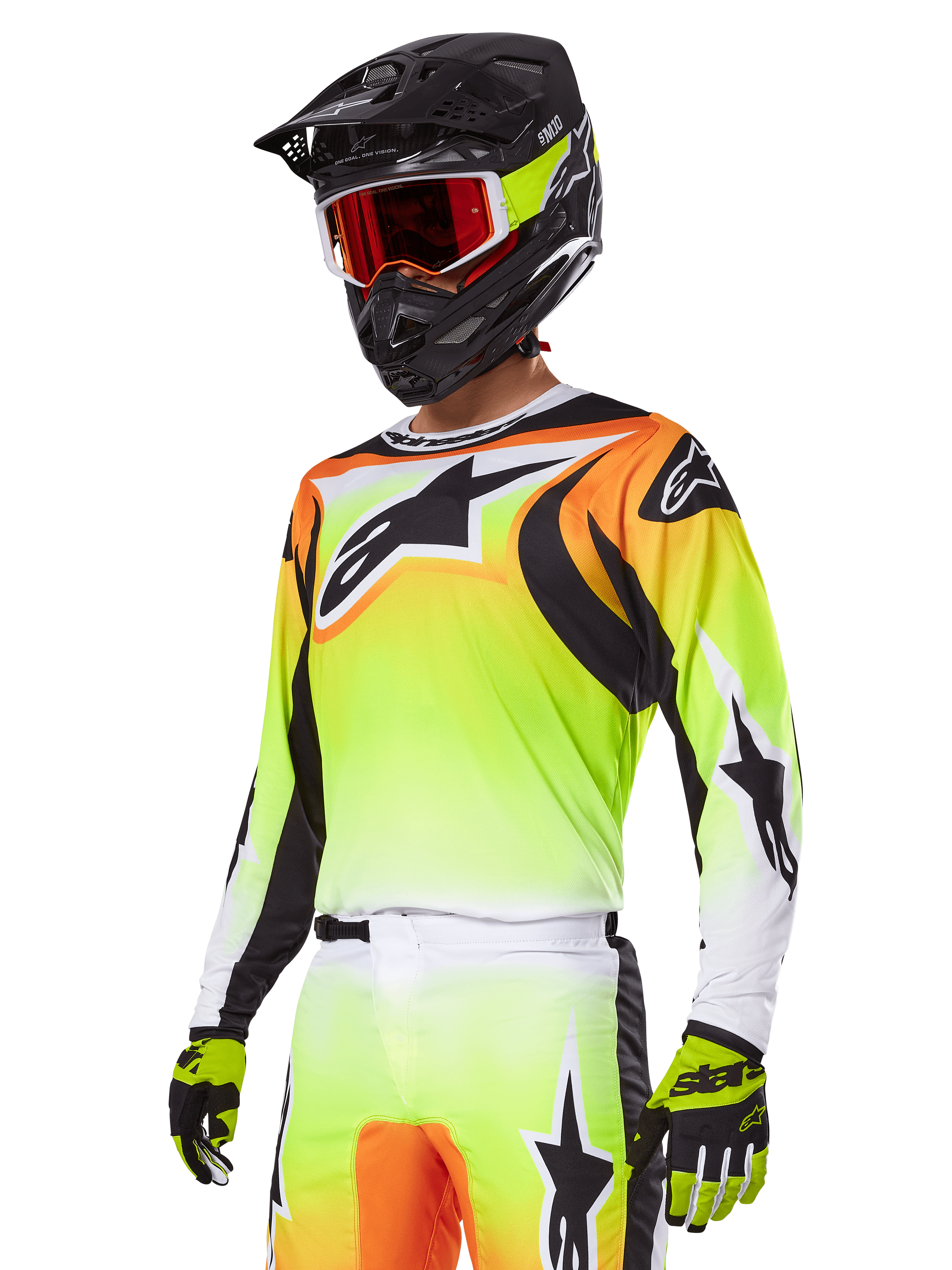 Piloto de motocross con el conjunto de equipamiento Alpinestars 2025 Fluid Wurx, jersey con degradado en amarillo y naranja con detalles negros y grandes logotipos de estrella, pantalones de motocross a juego, casco integral negro con gafas de lente roja y guantes amarillos, atuendo coordinado de alto rendimiento para carreras off-road