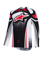 Jersey Alpinestars Techstar Nomur 2026, jersey de motocross, negro, blanco y rojo, con un gran logotipo Astars rojo en el pecho, patrones gráficos punteados, manga larga y un ajuste de carrera atlético para competición off-road de alto rendimiento.