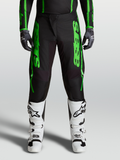 Alpinestars 2027 Fluid Apex V2 Pants, men's motocross gear in green and black, with reinforced knees and white boots.