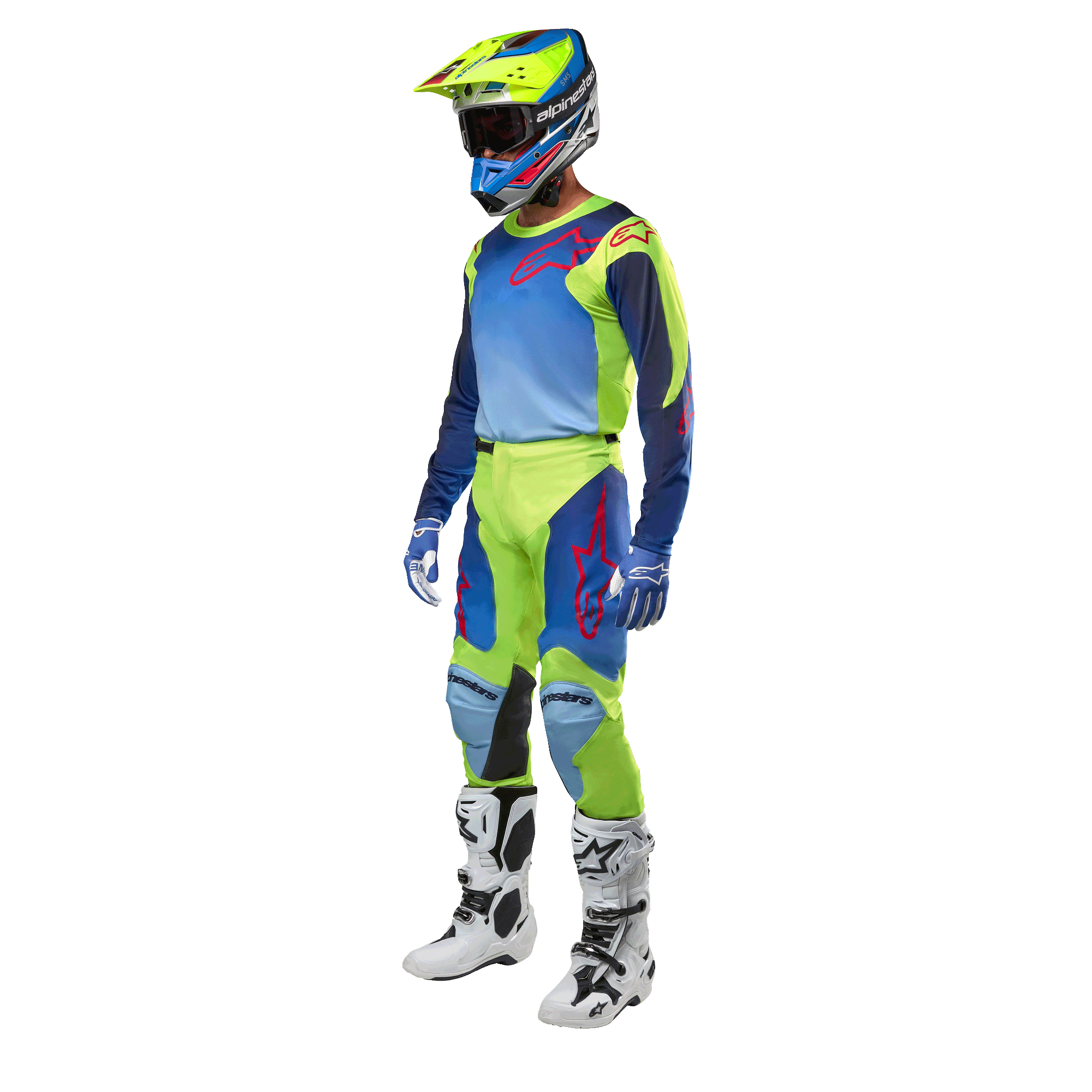 Alpinestars 2024 Racer Hoen Jersey, jersey de motocross, amarillo flúor y azul night navy, usado por un piloto con pantalones a juego, casco y botas blancas, equipamiento profesional para conducción fuera de carretera