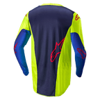 Jersey Alpinestars Racer Hoen 2024, camiseta de motocross, amarillo flúor y azul marino noche, vista trasera que muestra el panel central azul oscuro con logo rojo, secciones laterales amarillo brillante, manga larga y tejido de malla transpirable diseñado para el rendimiento off-road.