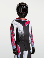Alpinestars Jersey Fluid Drag, jersey de motocross de hombre, negro y blanco con rojo y azul, tejido transpirable.