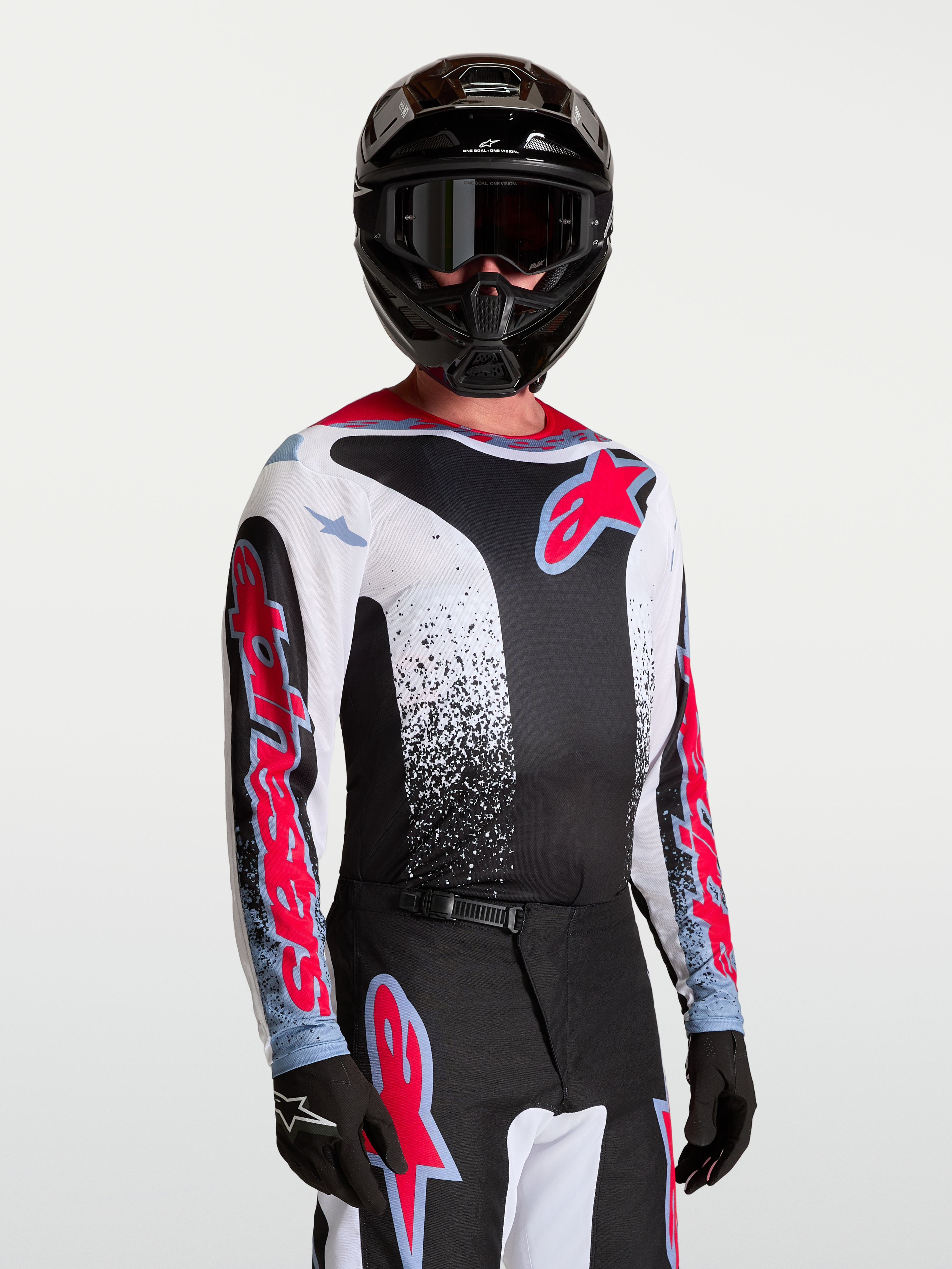 Alpinestars Jersey Fluid Drag, jersey de motocross de hombre, negro y blanco con rojo y azul, tejido transpirable.