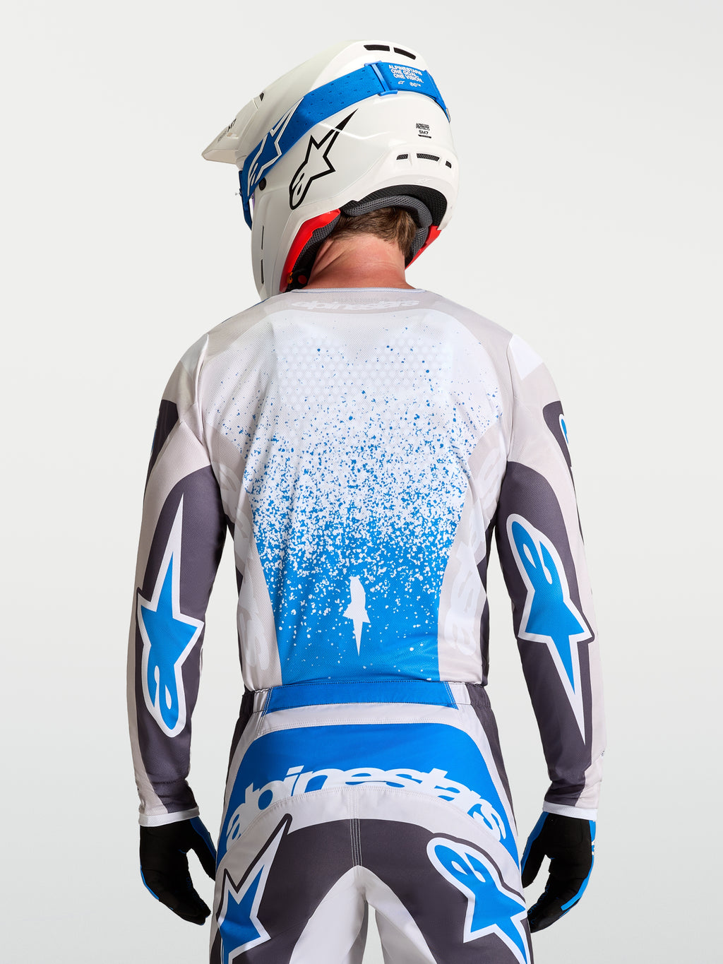 Alpinestars Jersey Fluid Drag, jersey de motocross para hombre, gris y azul, transpirable, vista trasera.