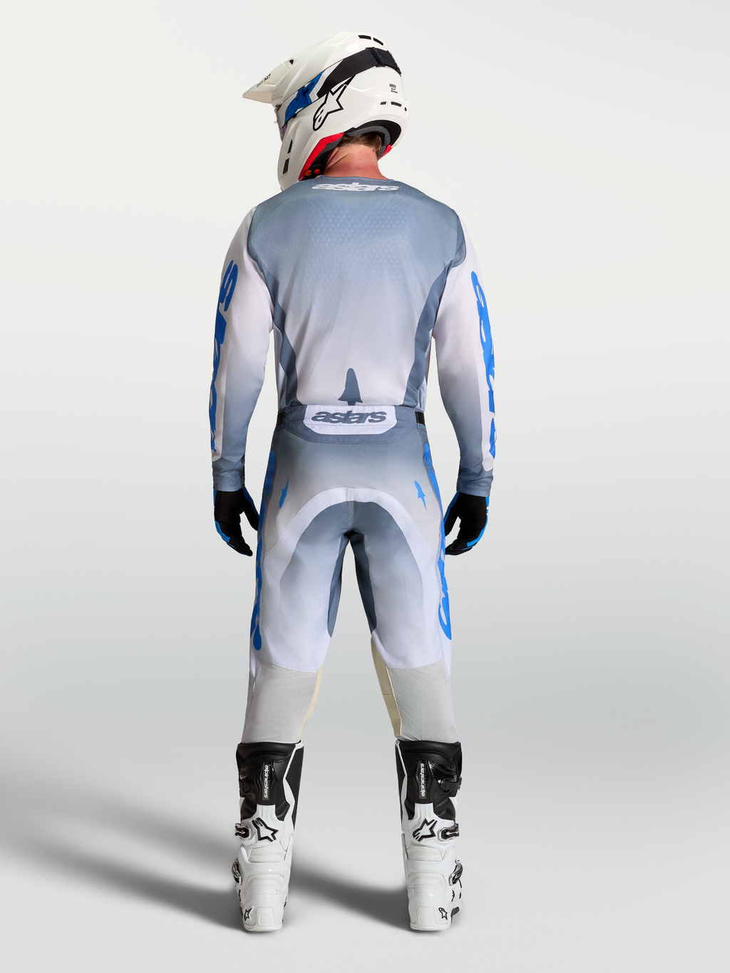 Alpinestars Racer Amber, conjunto de equipo de motocross para hombre, gris ceniza y azul UCLA, vista trasera.
