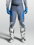 Alpinestars 2027 Racer Amber Pants, Men's Motocross Gear in Ash Gray and UCLA Blue, shown on-model with white racing boots.