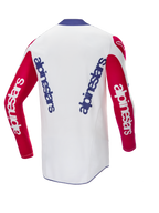 Alpinestars Limited Edition Techstar Fortitude Jersey, jersey de motocross, rojo brillante, blanco y azul, vista trasera con marca azul vertical en la espalda blanca y mangas rojas, ajuste de alto rendimiento para motocross