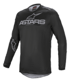 Alpinestars Fluid Graphite Jersey, jersey de motocross, negro y gris oscuro, con el logotipo ASTARS en gris en el pecho y el hombro, logotipo de estrella en la manga, construcción de malla técnica de manga larga para competición off-road