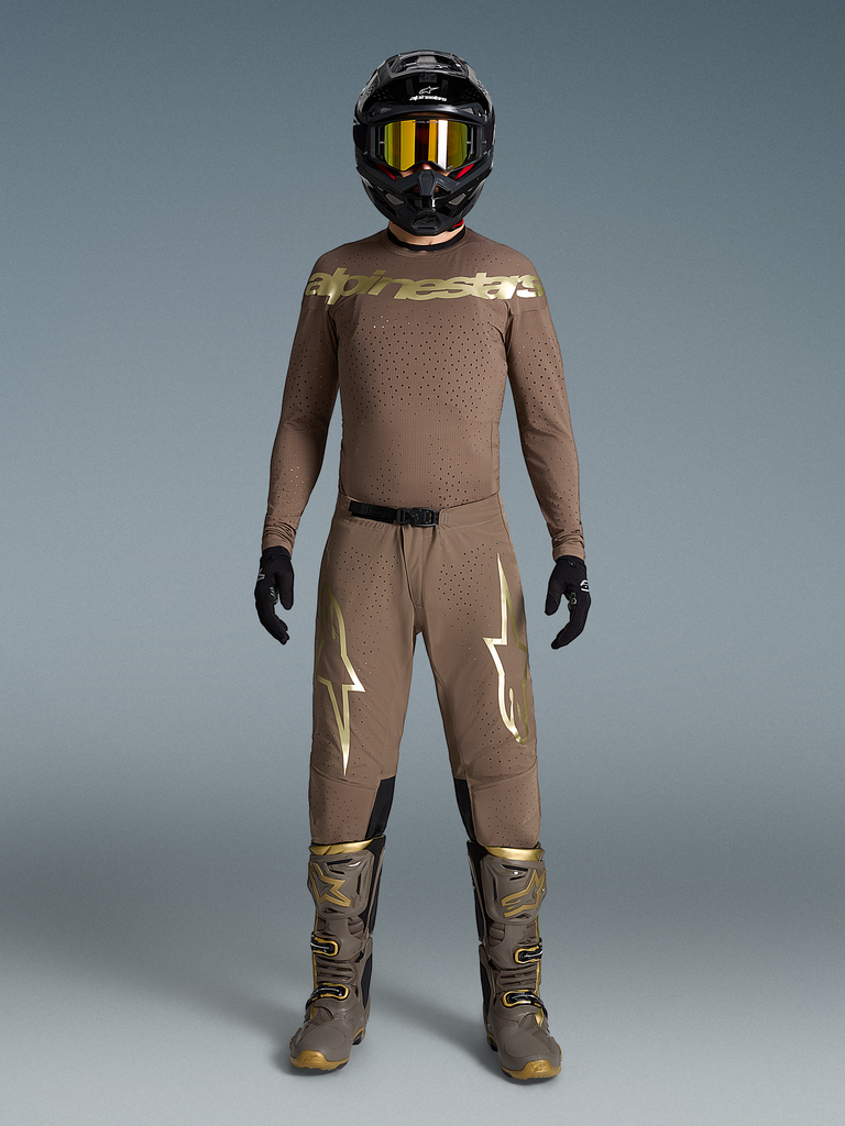 Conjunto Supertech Air Gold Edición Limitada, equipo de motocross marrón con logos dorados, botas y casco a juego.