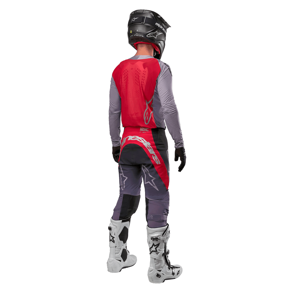 Alpinestars 2024 Supertech Dade Jersey, Motocross Jersey, Iron Red Berry and Grey, back view on a rider, featuring a red back panel with a grey logo and grey sleeves, worn with coordinating grey and red racing pants, white boots, and a black helmet, professional off-road gear.