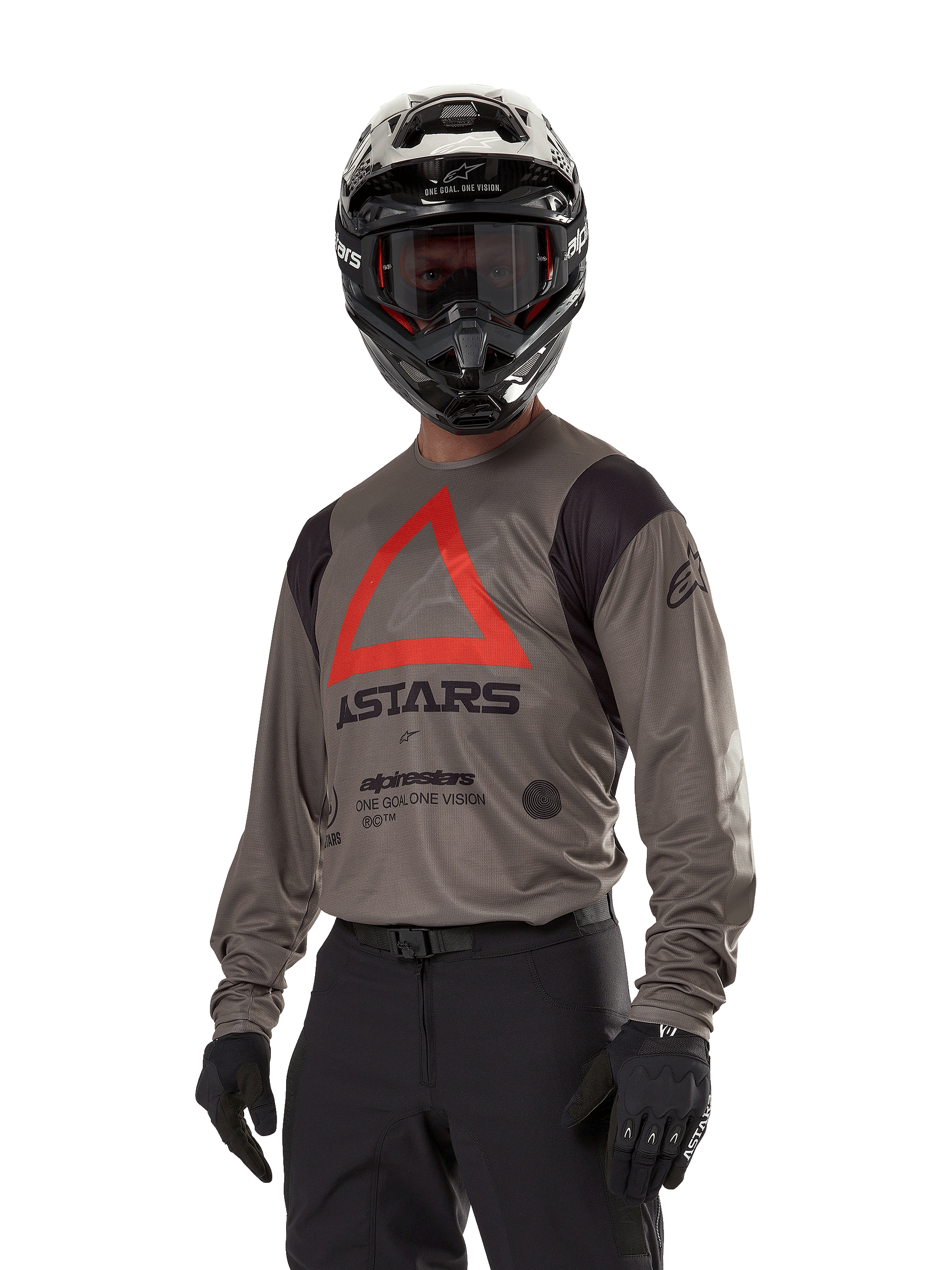 Alpinestars Techdura Jersey, Motocross Off-road Jersey, Falcon Brown with Red Triangle and black branding, worn with black pants, black and white helmet, and black gloves