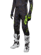 Alpinestars 2024 Techstar Rantera Pants, Motocross Pants, Black Navy and Yellow Fluo, featuring navy camouflage patterns and neon green branding, worn with matching gloves and white boots, durable racing-fit design for off-road performance