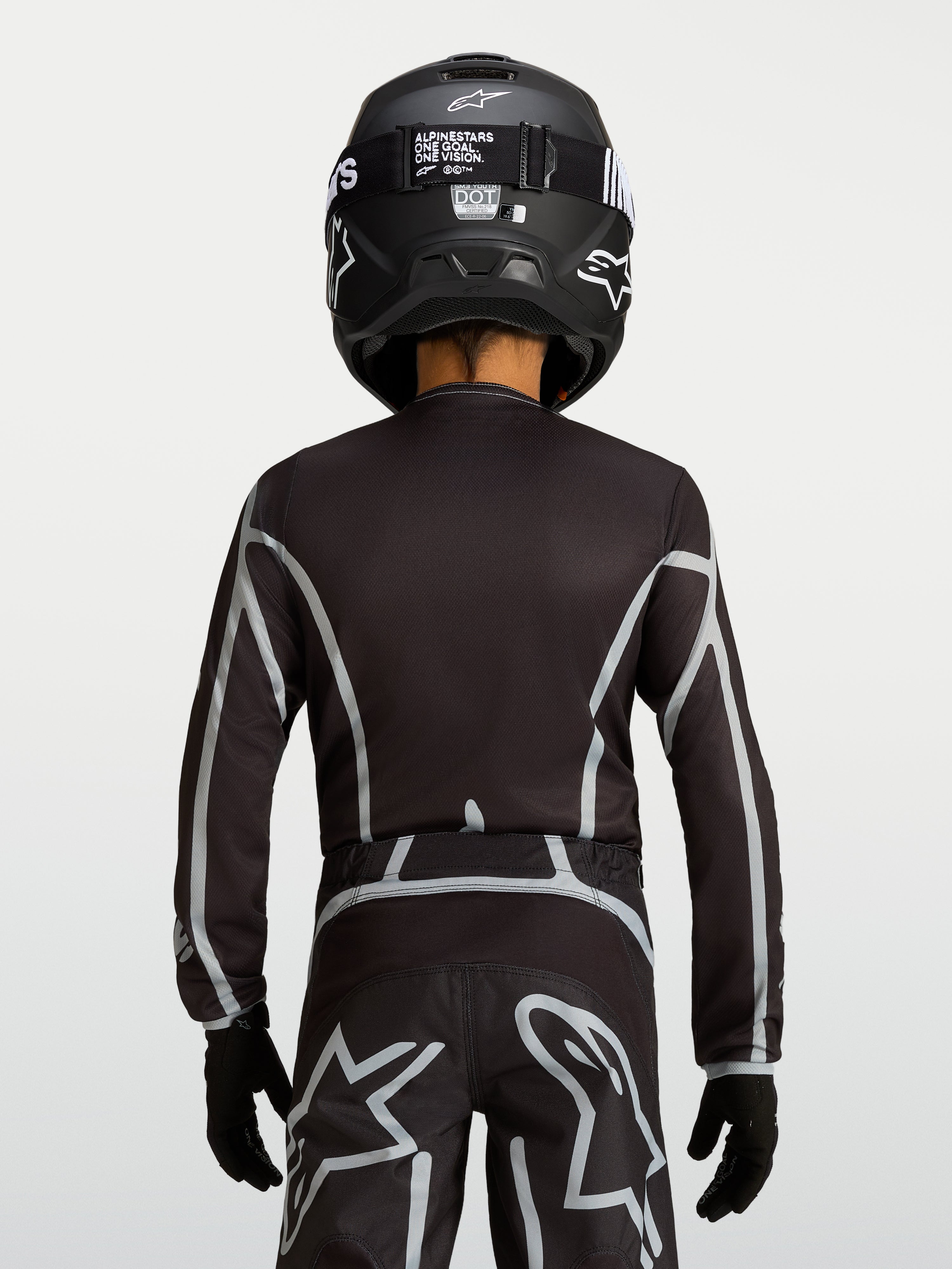 Alpinestars Youth Fluid Apex V2 Jersey, Black and Silver motocross top with ergonomic fit and extended rear coverage.