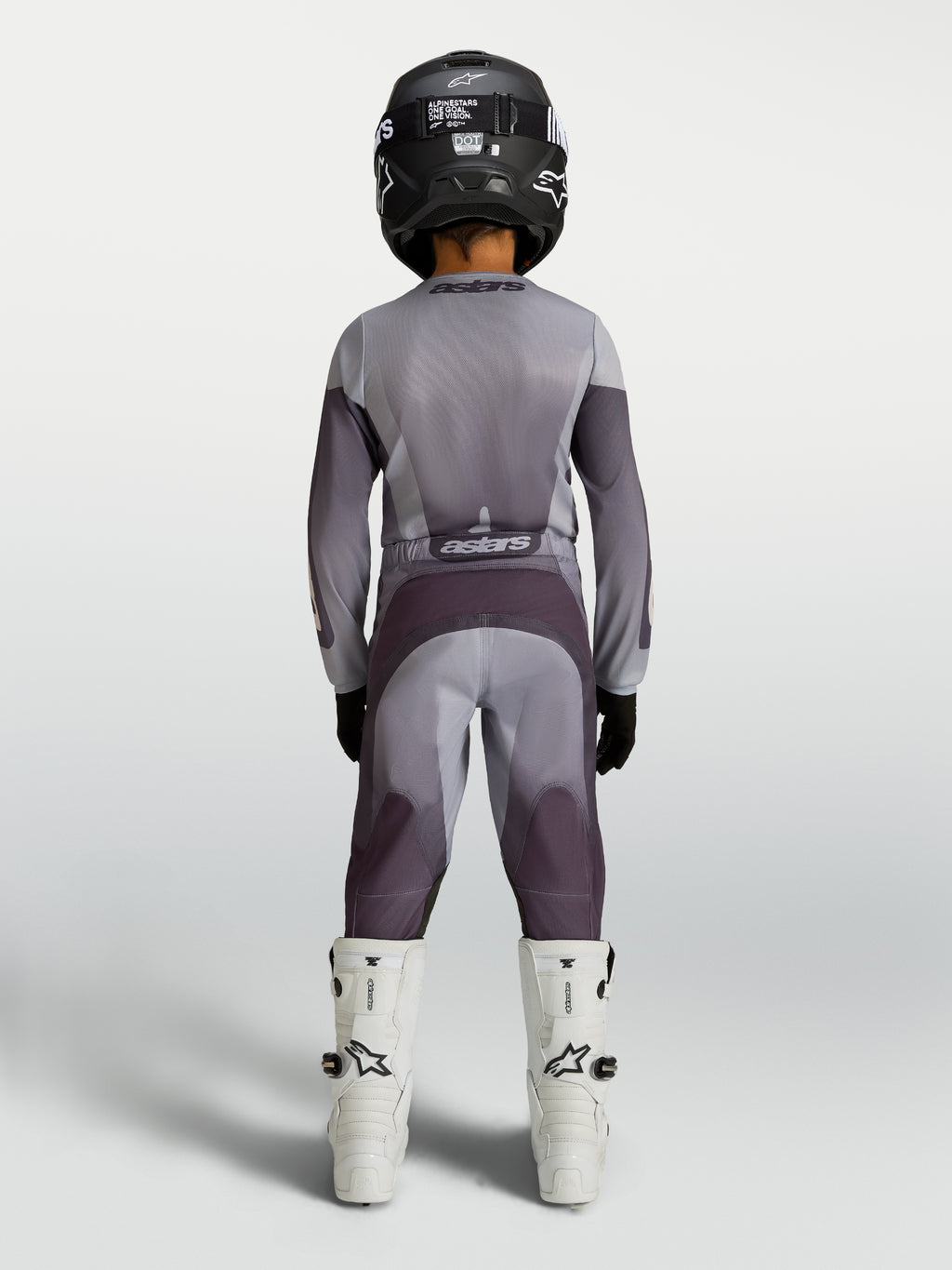 Alpinestars jersey Fluid Amber juvenil 2027 y conjunto de equipo de motocross, gris y morado, vista trasera sobre piloto juvenil
