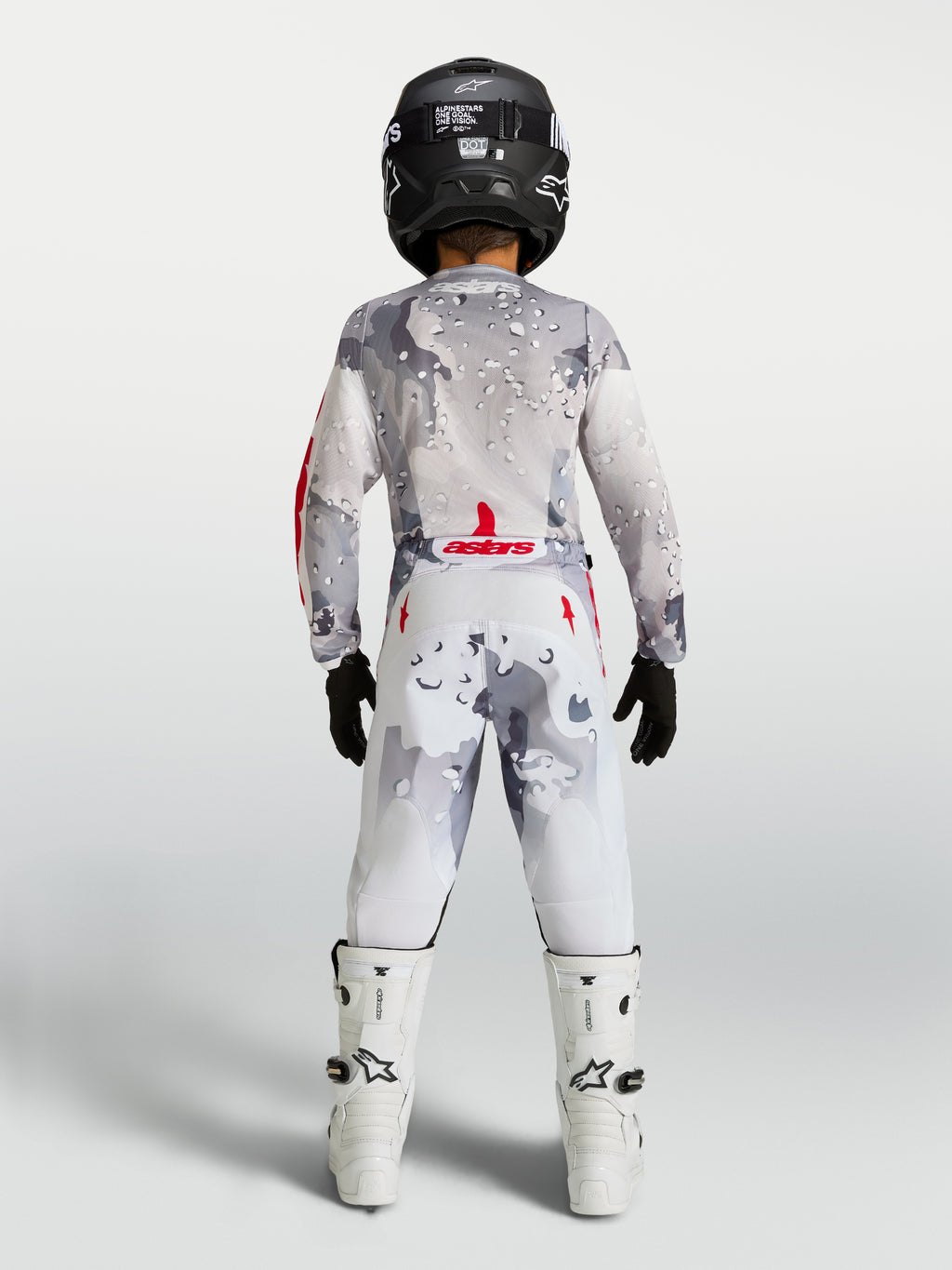 Alpinestars Fluid Lone 2027 juvenil, conjunto de motocross gris camuflaje y blanco con detalles rojos, vista trasera