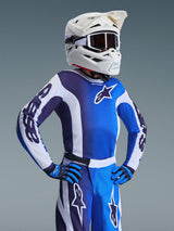 Alpinestars 2026 Youth Fluid Portl Jersey, Motocross Jersey, Ucla Blue and White, featuring a color-blocked design with stars logo, worn with matching pants, gloves, and a white helmet with goggles, coordinated youth racing gear